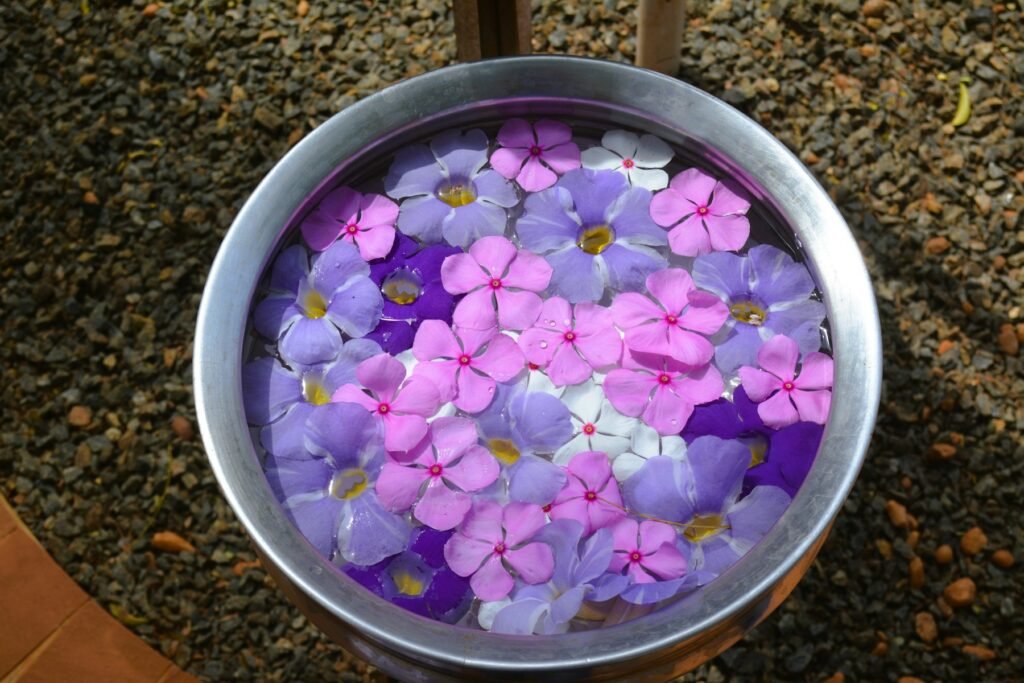 Metal urli with floating flowers